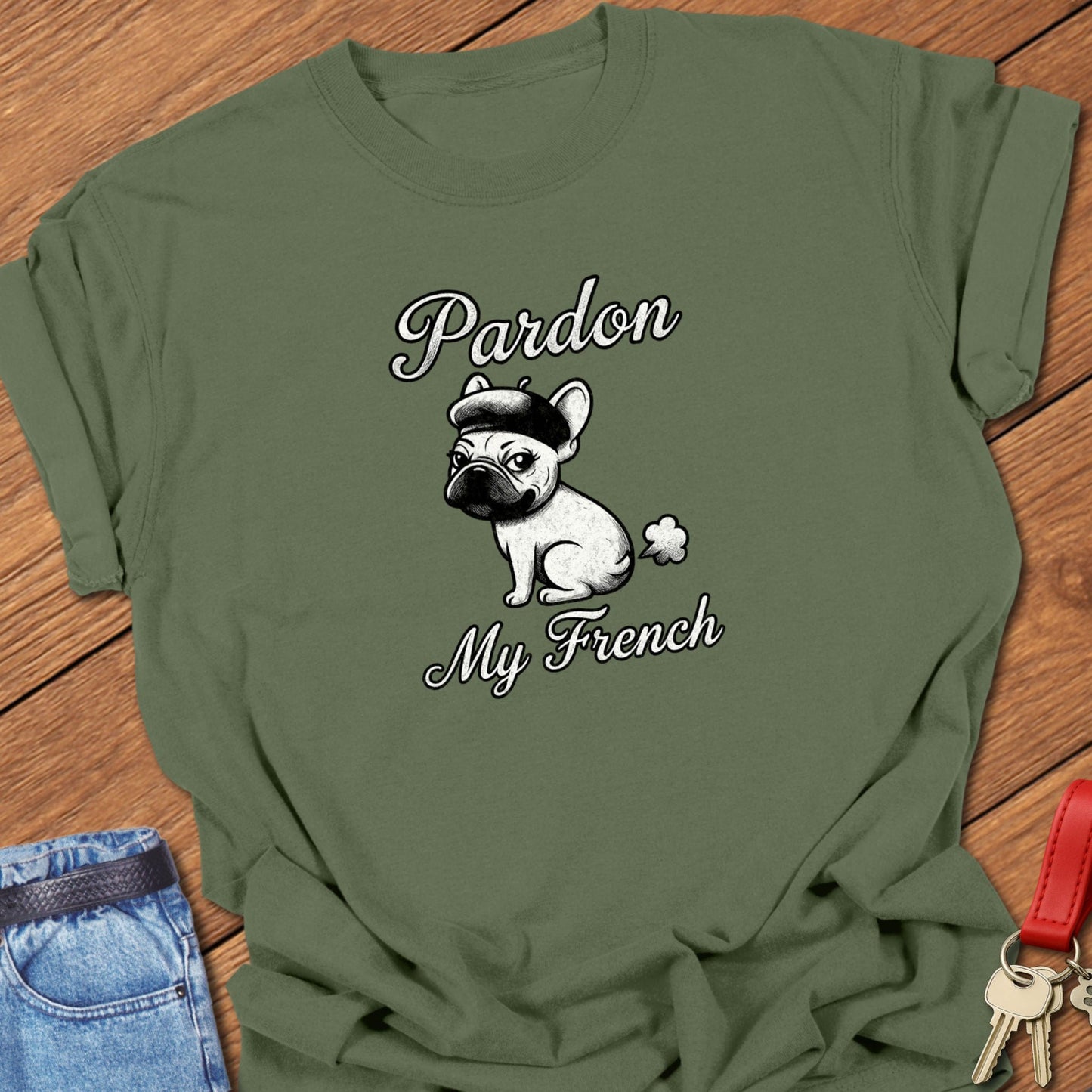 French bulldog illustrated wearing a beret with “Pardon My French” typography printed on moss Comfort Colors t shirt